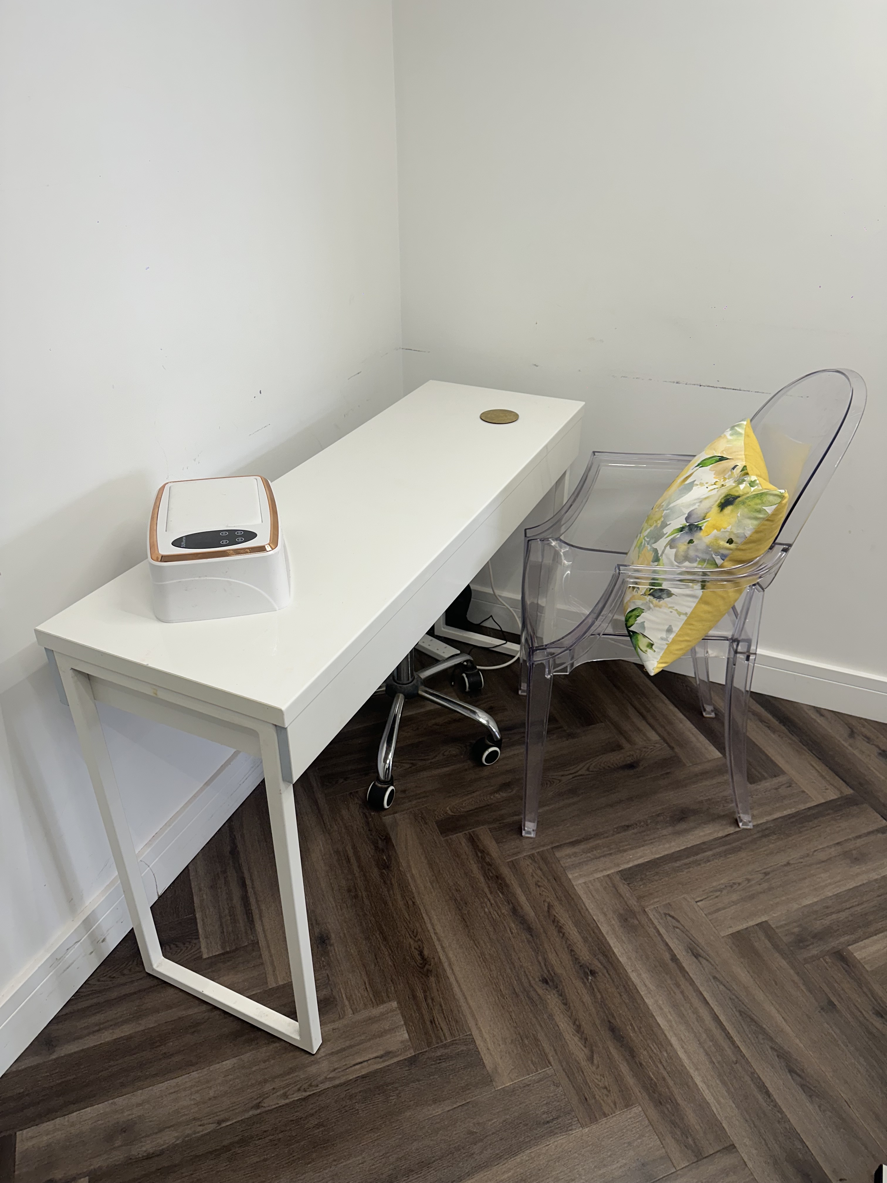 The nail station at Radiant by Fran with white desk, paraffin warmer and ghost chair
